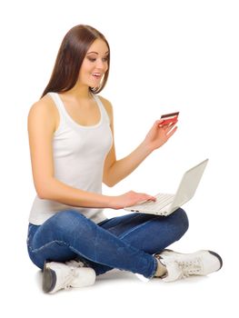 Young girl with laptop and credit card isolated