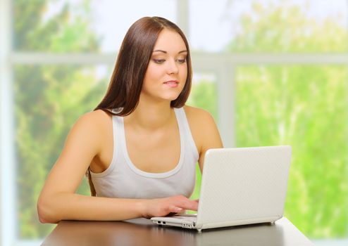 Young girl with laptop at home