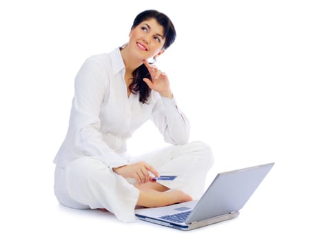 Smiling young woman with credit card and laptop isolated