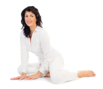 Young smiling woman sitting on floor isolated