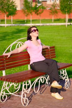 Young smiling woman on a bench