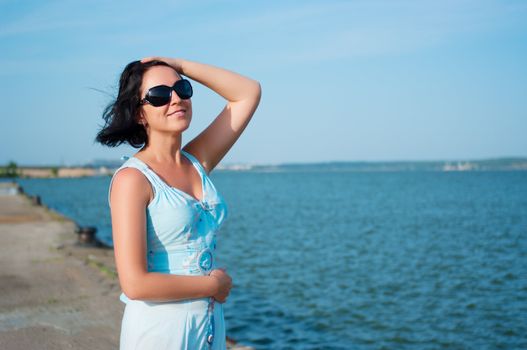 Young smiling woman on quay