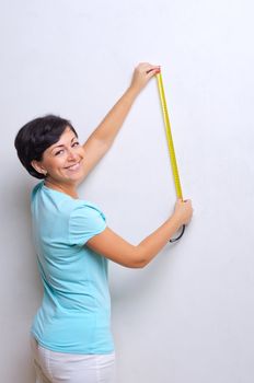 Smiling woman with measurement tape