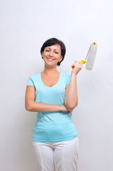 Smiling woman with painting roller