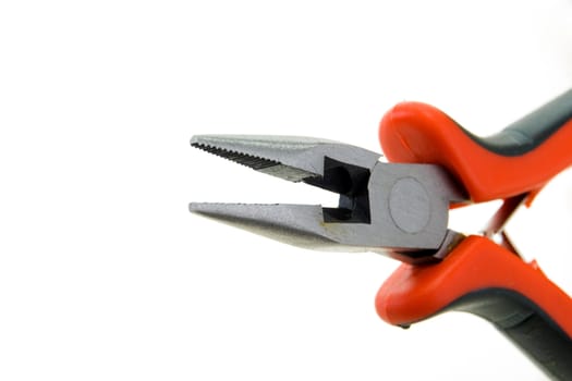 Steel pliers with plastic color handles on a white background