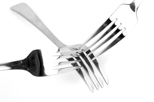 Shiny stainless steel forks on a white background