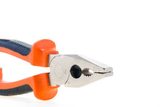 Steel used pliers with plastic color handles on a white background