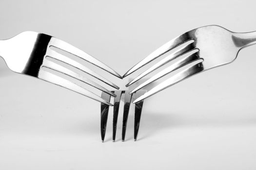 Shiny stainless steel forks on a white background