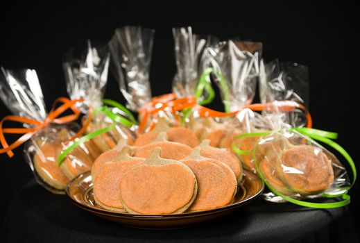 Homemade pumkin cookies on isolated black background.