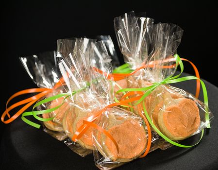 Homemade pumkin cookies on isolated black background.