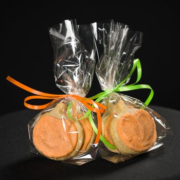 Homemade pumkin cookies on isolated black background.