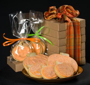 Homemade pumkin cookies on isolated black background.