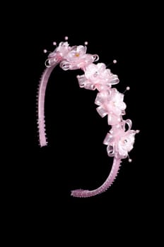 pink  floral headband isolated on black background with path.