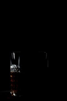 Old whiskey glass on a black background