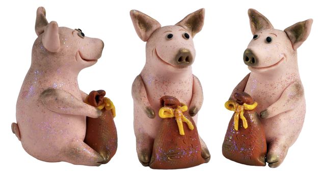 Toy pigs with a bags of money, a symbol of riches and Eastern New year. Handmade, made from the salty dough