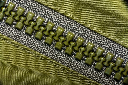 macro of green plastic nylon zipper