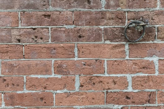 Rough red brick wall with iron link background