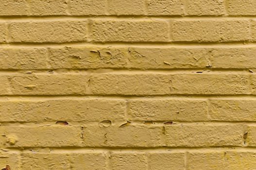 Yellow old painted brick wall background