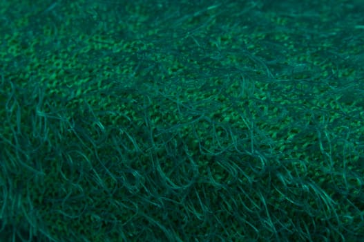 Close up shot of plastic green textured sponge.