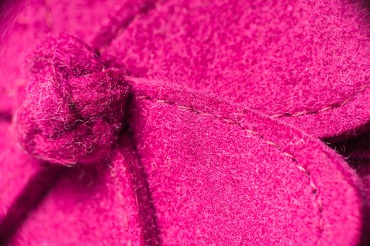 Macro shot of a pink hand made felt flower.