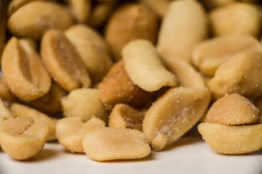 Close up shot of yellow peanuts in a pile.