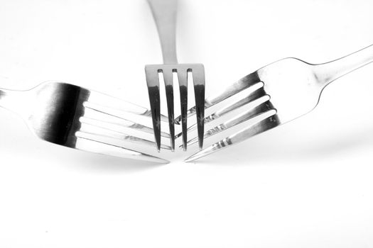 Shiny stainless steel forks on a white background