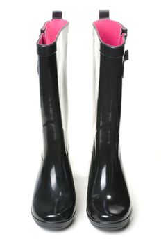 black rubber boots on white background with pink insides.