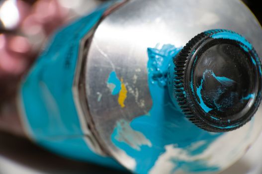 Macro shot of blue metal paint tube