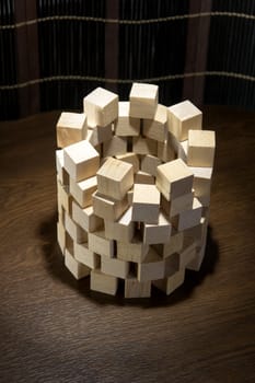 Tower of wooden blocks, built on a wooden surface