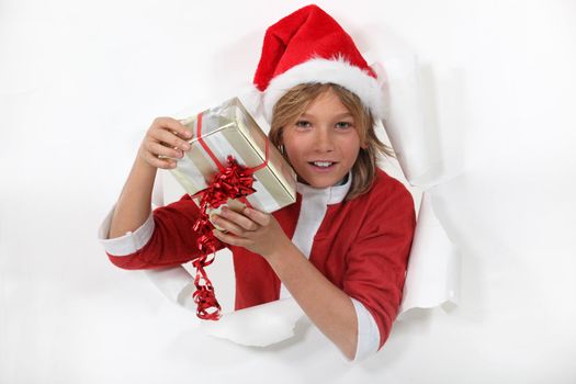 Young Santa Claus holding a gift