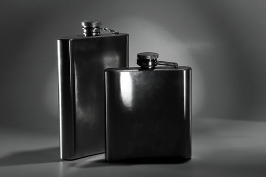 One of the most favorite men's toy - a metal flask for alcoholic beverages. Two used jars of stainless steel for whiskey or brandy