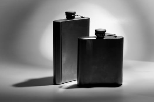 One of the most favorite men's toy - a metal flask for alcoholic beverages. Two used jars of stainless steel for whiskey or brandy