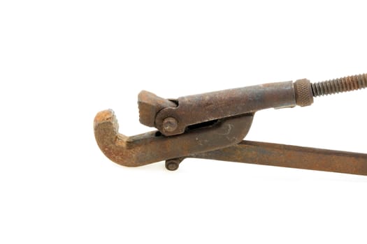 Big used rusty wrench on white background.