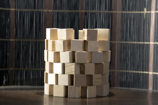 Tower of wooden blocks, built on a wooden surface