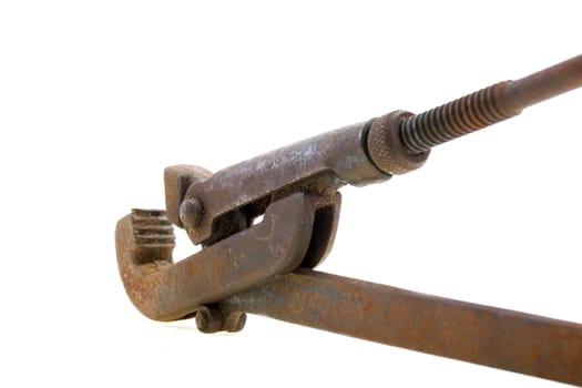 Big used rusty wrench on white background.