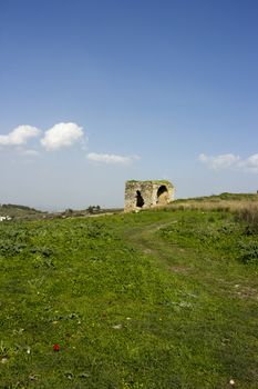 Old abandoned standing alone ruined house