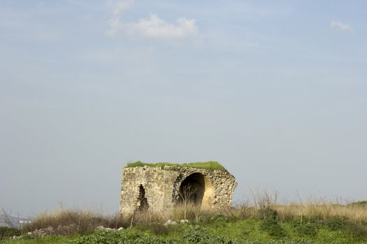 Old abandoned standing alone ruined house