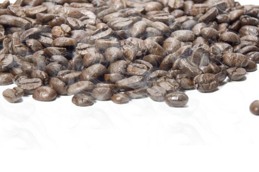 Fresh roasted coffee beans on a white background