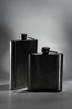 One of the most favorite men's toy - a metal flask for alcoholic beverages. Two used jars of stainless steel for whiskey or brandy