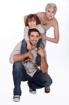 Young family posing in a studio