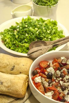 Green salad, chopped  tomatoes, cheese, olives, bread