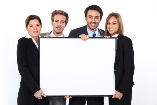 Business team holding blank poster