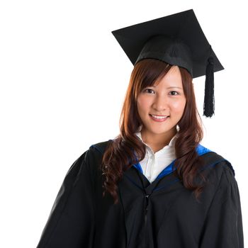 Portrait of smiling Asian female student in graduate gown isolated on white background