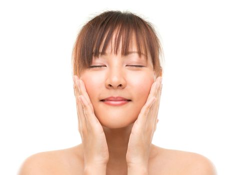 Asian skincare woman pampering face skin, skin care refreshing concept. Facial close up of beautiful mixed race Asian. Girl isolated on white background