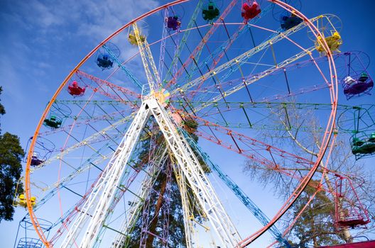 Ferris wheel on the blue sky background