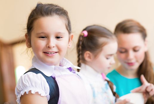 Portrait of Asian girl in apron interested in painting at an art school