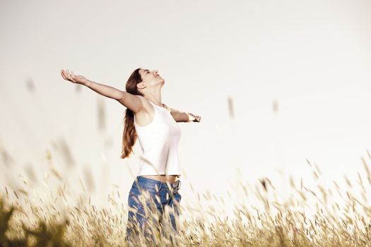 Outdoor portrait of a woman on a meadow releaxing