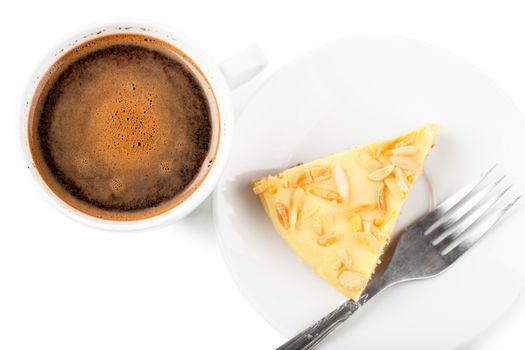 Top view of cup of coffee and pie on a white plate