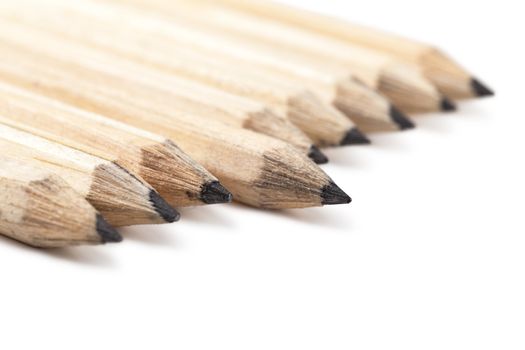 Macro view of group of lead pencils over white background