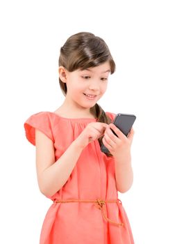 Wondering little cute girl in red dress surprised with an interesting information on mobile smartphone. Isolated on white background